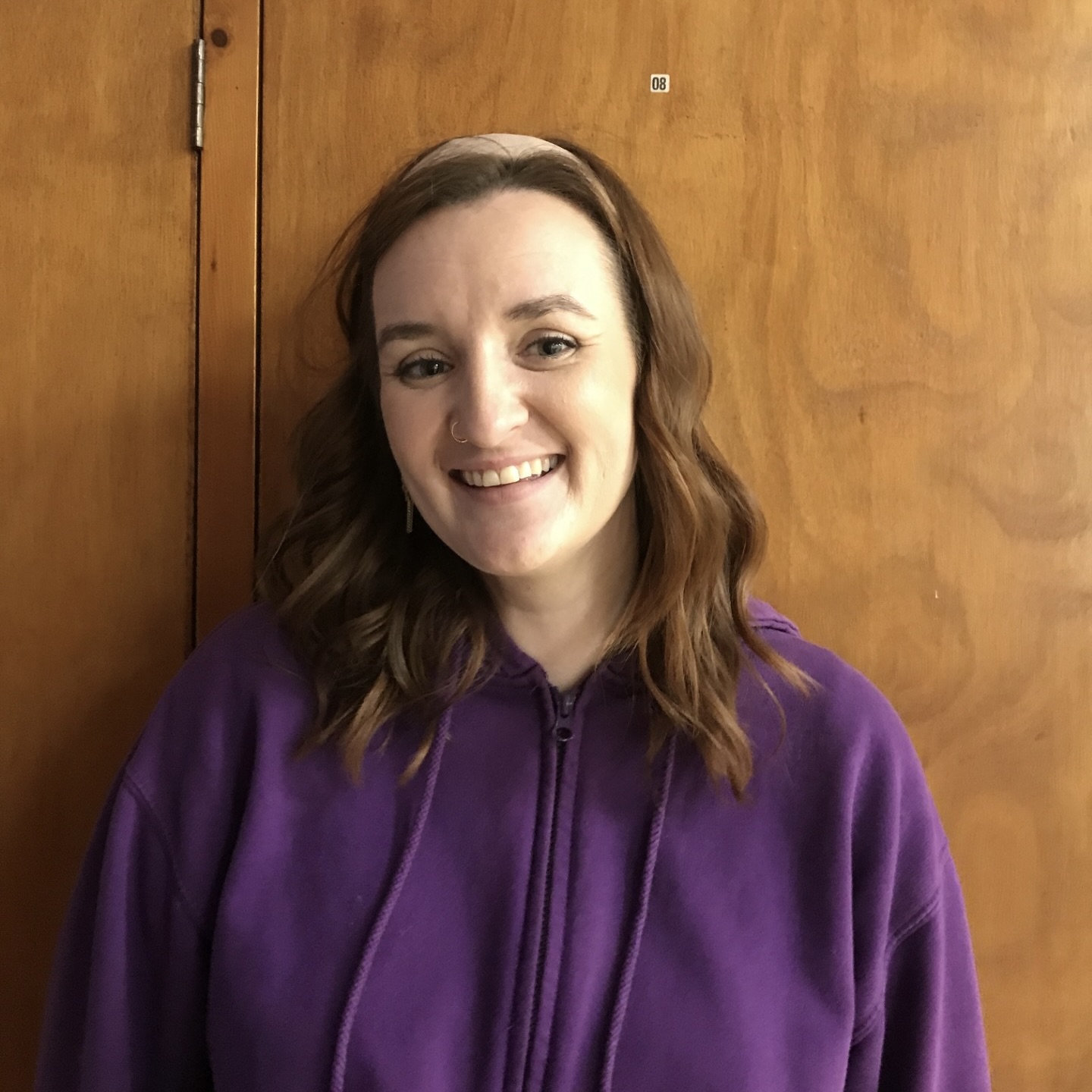A photo of Rhiannon, a white woman with long hair, smiling.